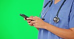 Phone text, green screen and woman hand of nurse in a studio with mobile communication. Female, healthcare and worker on a web chat and social media app scroll of a hospital and clinic employee