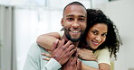 Portrait, love and a couple hugging in their home while bonding together in the living room for romance. Smile, happy or dating with an affectionate boyfriend and girlfriend embracing in their house