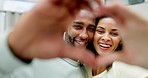 Couple, smile and heart hands in home for face, love or romance, affection or care. Emoji, interracial portrait and black man and funny woman laugh with hand gesture for bonding, trust or commitment.