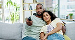 Relax, sofa and couple watching tv in home, bonding and enjoying time together. Interracial, streaming and happy black man and woman watch movie, video or film on couch in lounge, cuddle and talking.