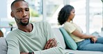 Couple, divorce and ignore with stress on sofa in home after fight, mistake or infidelity. Interracial, cheating and sad, unhappy and depressed black man and woman with conflict or marriage problem.