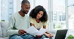 Discuss, laptop and couple with paperwork for finance, taxes or savings on sofa in home. Interracial, documents and black man and woman with computer for planning budget, insurance or financial bills