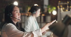 Call center computer, consulting or Asian woman explaining in telecom, customer services or communications. Computer or mature agent in microphone headset at crm or technical support office at night 