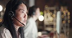 Crm, communication or Asian woman consulting in call center helping, speaking or talking at customer support. Sales, night or mature consultant in telemarketing or telecom company in a conversation