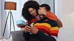 Black couple, surprise gift and couch in home living room for birthday, anniversary or celebration for texting man. Woman, present and boyfriend on sofa with smartphone chat, social media and smile