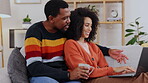 Relax, browsing and interracial couple with a computer on the sofa for the internet. Talking, happy and black man and woman speaking while looking at a website on a pc, smiling and choosing together