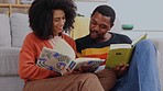 Black couple, reading and books on floor in home living room with happy discussion, bond and care. Man, woman and relax with review, book and happiness in house with love, quality time and education