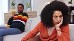 Couple, fight and angry on sofa for marriage problems, conflict and communication crisis. Divorce, argument and frustrated partner, cheating man and sad woman in anger, affair and breakup in lounge