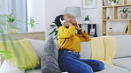 Dance, phone and music with black woman on sofa for freedom, carefree and streaming. Energy, mobile radio and happy with female and headphones at home for audio, subscription service and connection