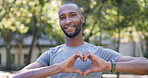 Fitness, man and hands in heart for love, healthy wellness or cardio workout exercise in nature. Portrait of happy and active male runner showing loving emoji, sign or symbol for physical wellbeing