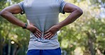 Fitness, man and back pain for runner in park with injury, ache or muscle problem while training in nature. Spinal, issue and sports guy suffering discomfort, strain or injured spine after forest run