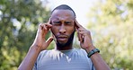 Fitness, headache and black man in pain while training in a park, unhappy and temple massage. Workout, migraine and male runner suffering after exercise run in nature, fatigue or discomfort in forest