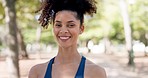 Fitness, face and happy woman runner in a park for exercise, training and morning cardio in nature. Portrait, smile and girl relax in a forest after running, workout and marathon practice routine