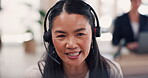 Asian woman, call center and face with headphones consulting on computer in customer service or support at the office. Happy female consultant talking with headset mic on PC for online advice or help