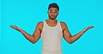Muscle, confused and flexing man shrugging shoulder feeling unsure and isolated in a studio blue background. Strong, male and portrait of clueless bodybuilder asking a question with doubt