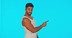 Fitness information, green screen and man pointing at mockup space for info or tips on body growth in studio. Mock up, exercise and healthy motivation by Indian personal trainer or sports instructor.