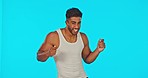 Happy, dance and face of a male in a studio with music, radio or playlist with a goofy attitude. Happiness, dancer and portrait of man model dancing to album with a smile isolated by blue background.