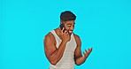 Phone call, conversation and a man on a blue background in studio talking with excitement on his mobile. Contact, hand gesture and communication with a male chatting or speaking using a smartphone