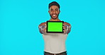 Face, green screen and man with tablet laughing in studio isolated on a blue background. Funny technology, mockup and happy male model with product placement, marketing or advertising for branding.