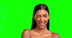 Face, wink and beauty of woman on green screen in studio isolated on background. Natural skincare, makeup cosmetics and portrait of Indian model or happy person with facial treatment for healthy skin
