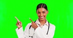 Happy, pointing and doctor in studio with green screen with mockup for advertising or marketing. Happiness, smile and portrait of female medical worker showing mock up space by chroma key background.