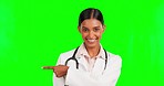 Face, pointing and doctor in a studio with green screen with mockup for advertising or marketing. Happy, smile and portrait of female healthcare worker showing mock up space by chroma key background.