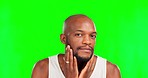 Grooming, beard and face of a black man on a green screen isolated on a studio background. Feeling, looking and portrait of an African guy touching his facial hair for maintenance on a backdrop