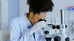 Woman, forensics and scientist looking in microscope for cure, discovery or breakthrough at the laboratory. Female doctor in science research, biology or working with microscopic organisms at the lab