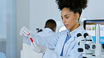 Woman, scientist and checking vial sample for testing, examination or scientific research in the laboratory. Female doctor in science with test tube for medical experiment for results or breakthrough