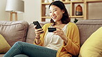 Happy, phone or girl online shopping with a credit card for discount or sale on digital fintech website at home. Financial ecommerce payment, smile or excited Asian woman on sofa banking on internet