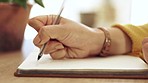 Woman, hand and notebook writing on paper at home working on study schedule and learning plan. Book, notes and house desk with a female student and creative writer busy with studying with a journal