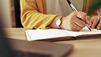 Woman, hand and writing in a notebook at home working on study schedule and learning plan. Book, notes and house desk with a female student and creative writer busy with studying with a journal