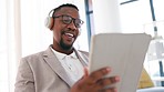 Tablet, headphones or black man on social media in office reading an email or content research online. Relaxing, digital news or happy business person listening or streaming online videos or music 