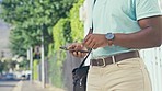 Closeup, outdoor and black man with smartphone, hands and travelling with connection, mobile app and chatting. Zoom, male and guy with cellphone, network signal and online reading for info and typing