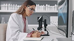 Science, microscope and computer with a woman writing notes while working on research in a laboratory. Innovation, notebook and sample with a young female scientist at work in a lab for breakthrough