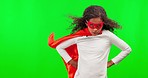 Wind, superhero and face of a girl on a green screen in a costume isolated on a studio background. Serious, power and portrait of a child dressing up as a hero for halloween on a chromakey backdrop
