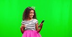 Princess, happy and kid in a studio with green screen in celebration of good news on a phone. Happiness, magic and girl child with a fairy cosplay outfit and cellphone by chroma key background.