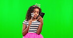 Phone, girl and princess with green screen and magic wand in studio isolated on a background mockup. Costume, crown and kid with tiara and cellphone for social media or online browsing on chroma key.