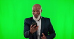 Phone, winner and a senior business black man on a green screen background in studio for celebration. Wow, contact and promotion with a mature male cheering a good news announcement on his mobile