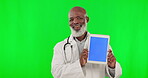 Doctor face, tablet and green screen isolated on studio background telehealth, medical or happy service marketing. Healthcare professional or senior black man show digital technology and mockup space