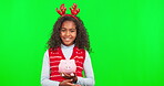 Christmas saving, piggy bank and child face with green screen and budget with happiness. Finance learning, smile and kid portrait with isolated and studio background with mockup and coin cash