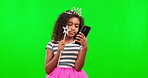 Phone, girl and princess on green screen with magic wand in studio isolated on a background mockup. Costume, crown and kid with tiara and cellphone for social media or online browsing on chroma key.