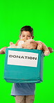 Green screen, donation box and child isolated on studio background for charity toys, volunteering service and support. Face of happy kid with container of teddy bear for ngo or nonprofit mockup space