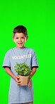 Volunteer, face and a boy with a plant on a green screen isolated on a studio background. Earth day, smile and a portrait of a child with peppermint plants for clean energy and growing ecology