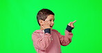Surprise, pointing and notification with a boy on a green screen background in studio for marketing. Kids, wow and hand gesture with a cute male child on chromakey mockup for branding or advertising