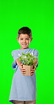 Children, plants and boy on a green screen background in studio for gardening or sustainability. Kids, portrait and earth day with an adorable little male child holding a potted plant as a volunteer