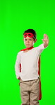 Stop, hand and superhero with child in green screen for warning, imagination and protest. Costume, power and fantasy with portrait of boy and gesture on background for crime, defense and attitude
