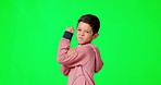 Strong, face and child in a studio with green screen flexing his arm muscles after exercise. Strength, comic and portrait of a boy kid model showing his biceps isolated by a chroma key background.