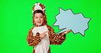 Pointing, speech bubble and child in costume in green screen studio for social media, promotion and news. Idea, mockup and youth or boy with sign on a background for announcement, opinion and show