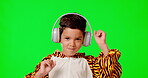 Dance, music headphones and kid in costume on green screen in studio isolated on a background. Dancing, face portrait and happy boy in tiger outfit streaming or listening to podcast, audio or radio.